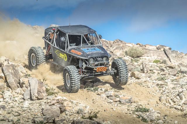 An off road vehicle descends a rocky hill