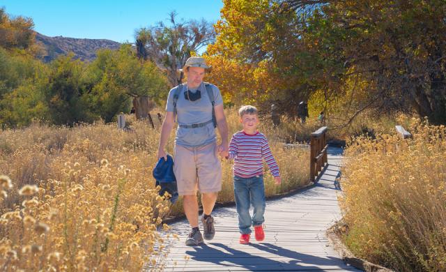 A father and son walk  the board  walk at Morongo Canyon