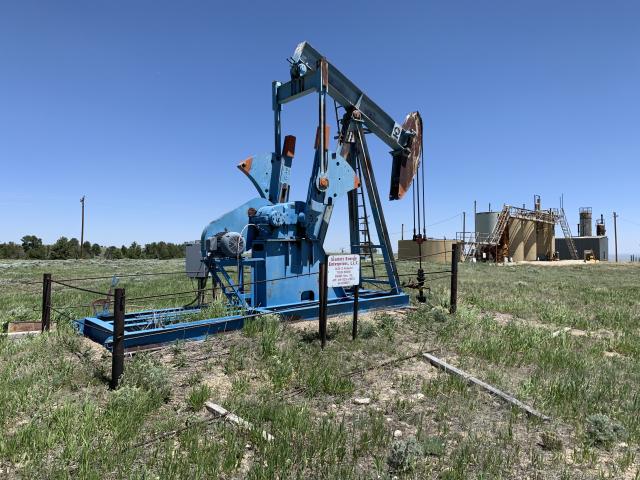 an oil well on a grassy plain