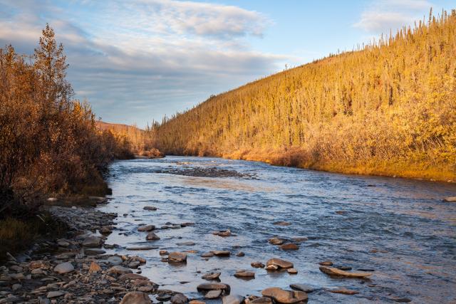 a sunset over a flowing river