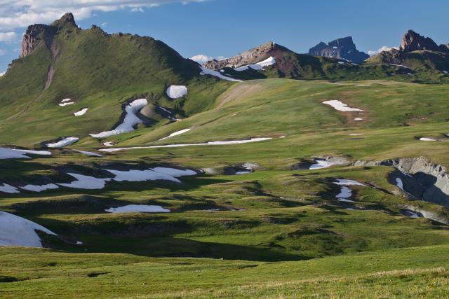 snow patches in a grassy canyon