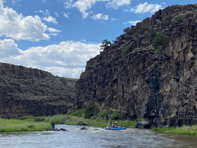 BLM staff and volunteers, along with two students and a teacher from the Bosque School, float in their rafts and inflatable kayaks as they depart from the Lobatos Bridge in Colorado.