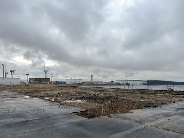 A construction site with air towers in the background