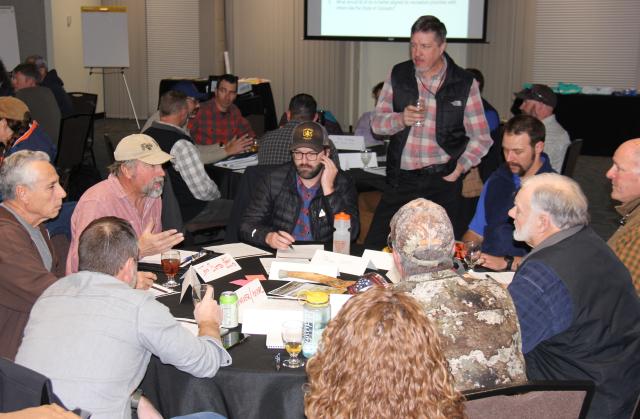 Attendees of a recreation summit participate in a discussion around a table at the Grand Junction Convention Center Jan. 13