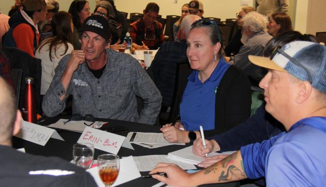 Recreation summit attendees engage in a discussion around a table at the Grand Junction Convention Center Jan. 13.