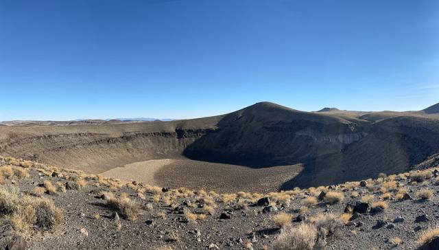 A wide shallow crater of desert sand