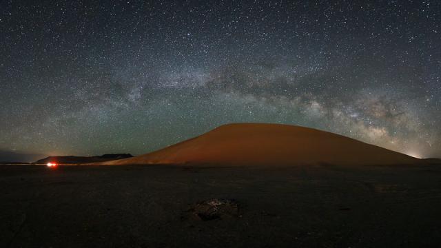 Night sky stars above a sand dune