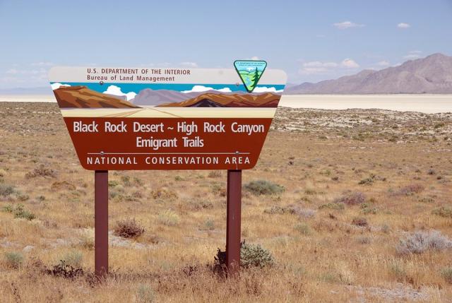 BLM entrance sign in front of a desert playa