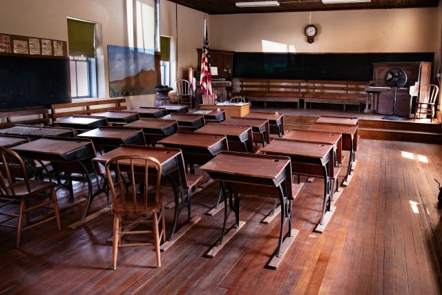 Rows of desks in a restored schoolhouse.