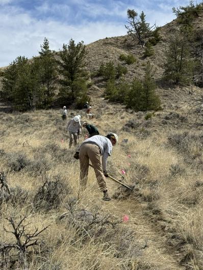 Photo of people performing maintenance on a dirt road