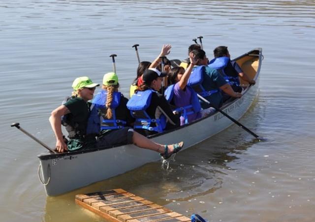 Students and chaperones piled into 10-person canoes with Wilderness Inquiry staff to take a spin around Cochiti Lake.