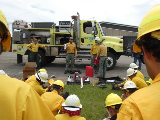 firefighters studying a pump engine