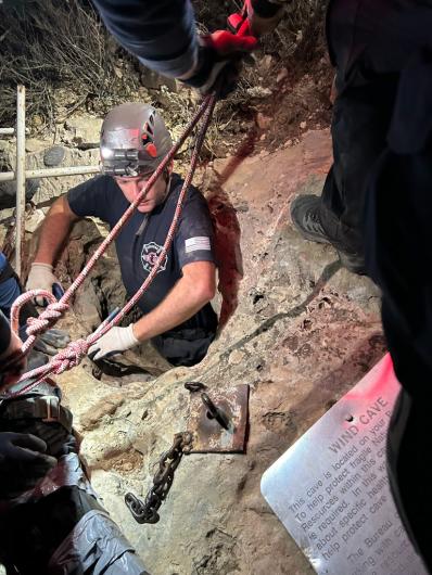 A firefighter enters the Wind-Hicks Cave near Carlsbad, N.M., during a cave rescue March 12.