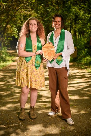 Nizhoni (Niz) Kears (left) and Nick Salgado-Stanley with a B.A.R.K. Ranger badge at the Headwaters Forest Reserve