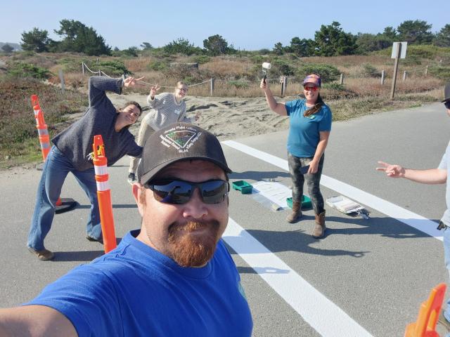 Volunteers paint crosswalks during a recent National Public Lands Day event held at the Samoa Dunes Recreation Area.