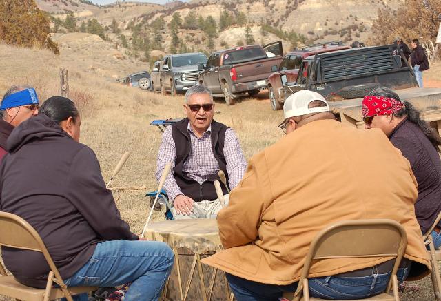 Northern Cheyenne historian Conrad Fisher (center) joins the drumming circle to sing with the rest of the group, after speeches were delivered March 17.