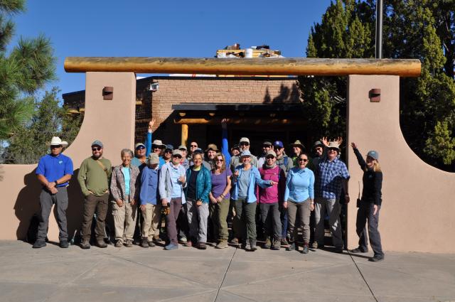 Volunteers and BLM staff pose in front of the BLM Ranger Station at El Malpais National Conservation Area.