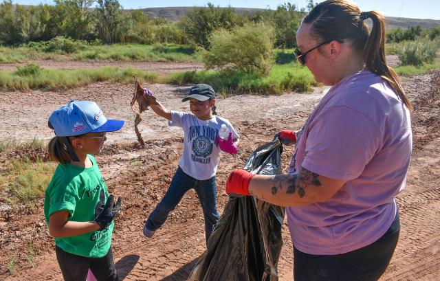 Members of Girl Scouts Troop 18044 and a parent pick up trash during a National Public Lands Day cleanup event at the Bureau of Land Management Roswell Field Office’s Oxbow Day Use Area on Sept. 12.