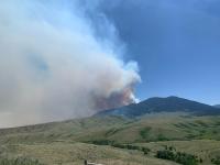 smoke rising over mountain