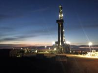 photo of oil rig lit up at night