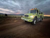 A fire engine on a dirt road