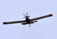 An Air Tractor 802 disperses seed.