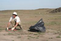 BLM employee rakes shotgun shells as part of clean up of north rim of Snake River Canyon