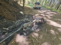 The remnants of the illegal dumping someone had set on fire. BLM photo.