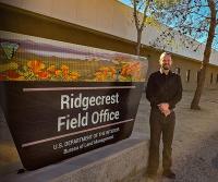 Philip DeSenze  in front of the Ridgecrest Field Office sign