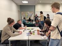 A group of youth talking to BLM Utah geologists around a table.