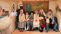 group of children in old time costume posing for a photo