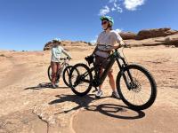 Mountain bike and e-bike user on a slickrock trail in Moab