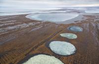 Several partially frozen lakes in late fall in the National Petroleum Reserve in Alaska.