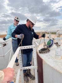 Students at PET Module 4 Oil Measurement gauge an oil storage tank to determine the quantity and quality of the oil in the tank.