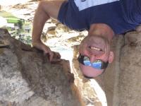 Close-up view of Matt Marsh, Challis Field Office's new field manager, wearing sunglasses and touching a large boulder.