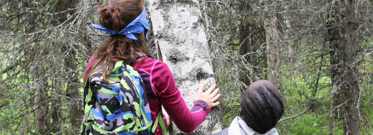 Two people doing the "Meet a Tree" activity outside