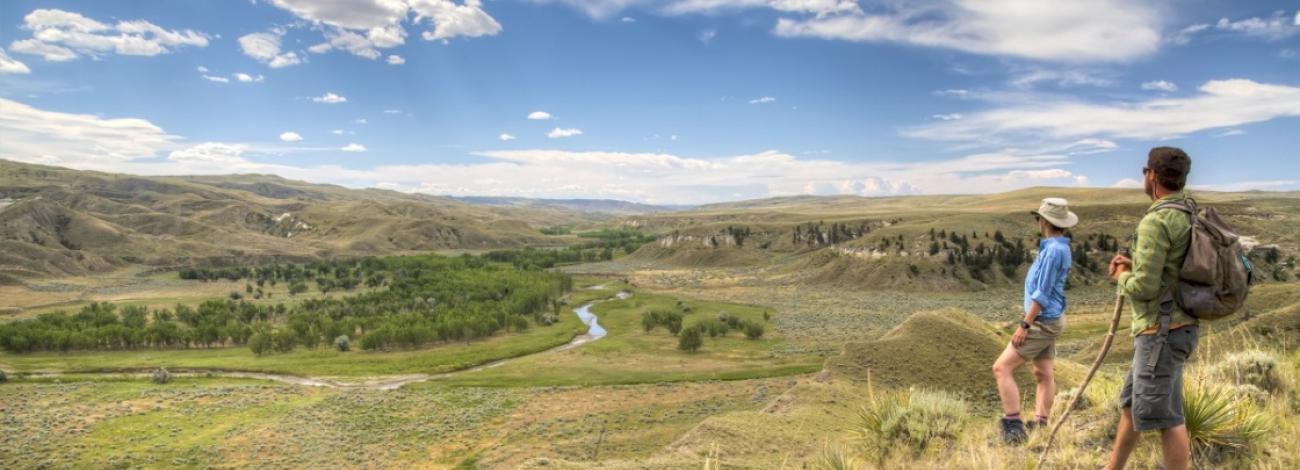 Two hikers stop on the Nez Perce National Historic Trail to overlook the valley, photo by Bob Wick