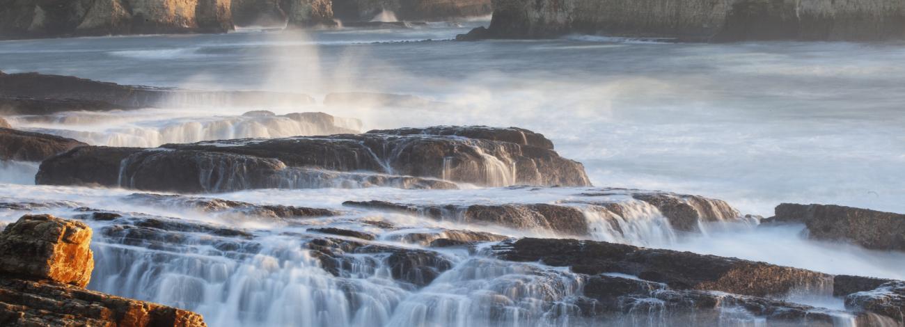 receding tide over rocky shores.