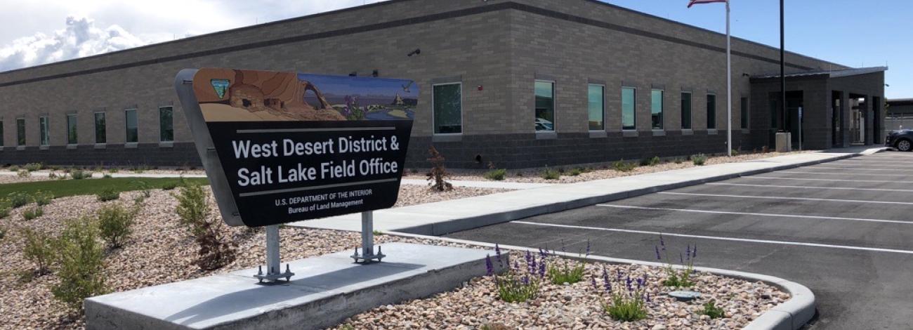 West Desert District & Salt Lake Field Office Sign with a building and parking lot.