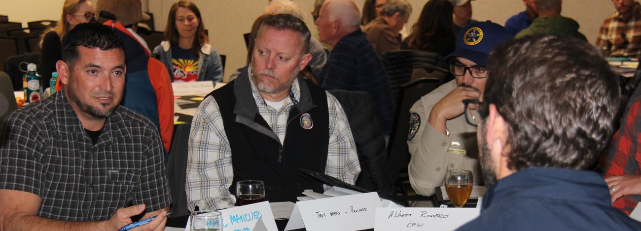 Recreation summit attendees participate in a discussion around a table at the Grand Junction Convention Center Jan. 13, 2025.