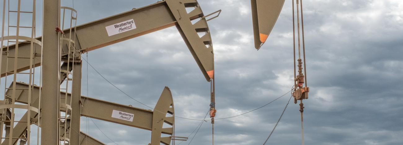 Photo of oil and gas drilling equipment under a cloudy sky