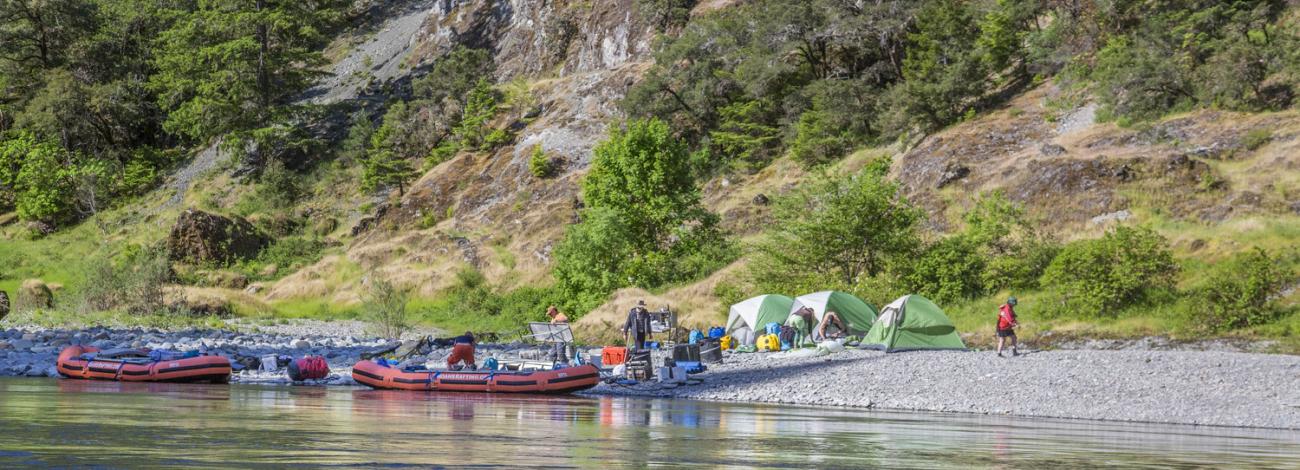 group of rogue boaters camping on a rocky shoreline