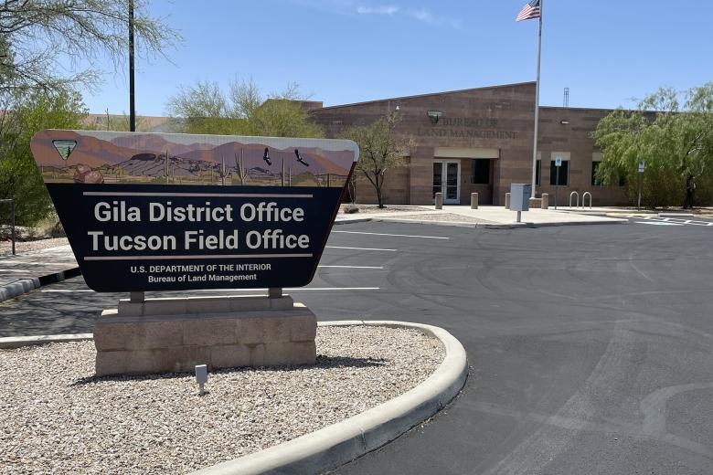Gila District and Tucson Field office sign in front of an office building with an American flag