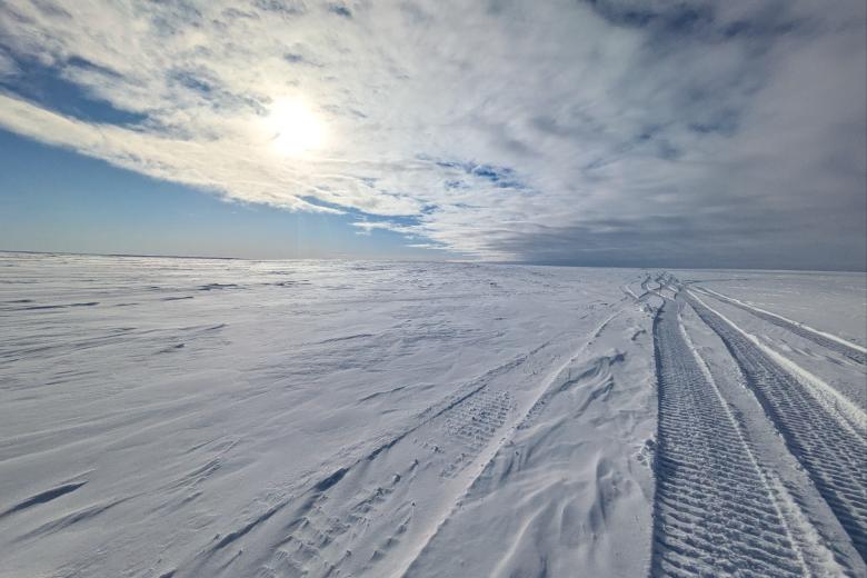Ice road on snow packed landscape of the National Petroleum reserve in Alaska in winter.