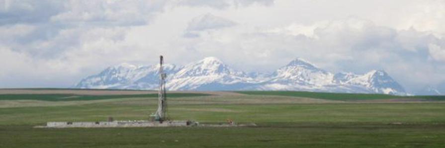 oil rig with mountains in background