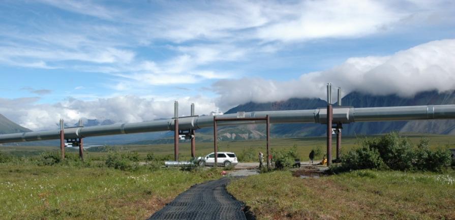 Car driving near elevated pipeline