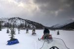 A rescue team riding snow machines