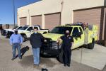 Members of the Colorado River District and Pinion Pine Fire Department stand in front of a fire engine. 