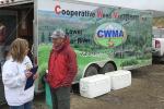 Lonnie talks to a woman with the weed truck in the background. 