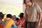 BLM Park Ranger Carty Carson points out the rock art identification to the students.